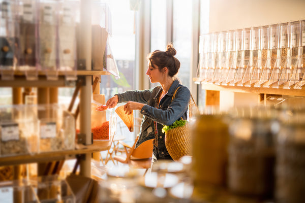 woman buying nutritional yeast in a grocery store